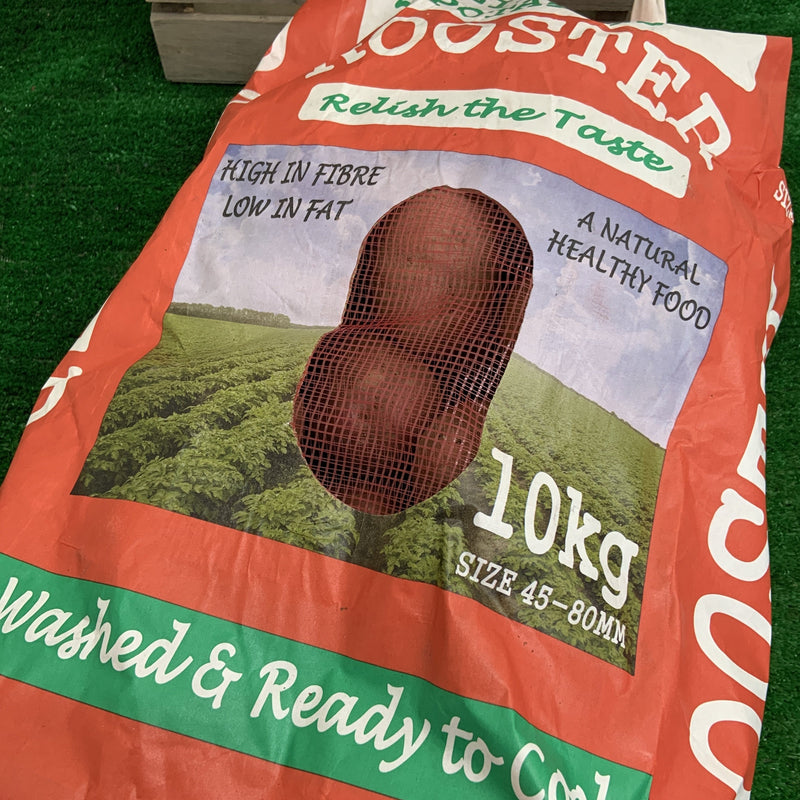 A large, red paper bag with a mesh hole showing red rooster potatoes inside.